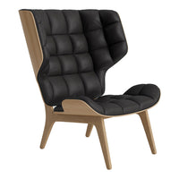 Black tufted fabric armchair with a wooden base, featuring a unique high-back design and modern aesthetic.