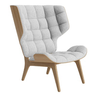 Gray tufted fabric armchair with a wooden base, featuring a modern design and soft contours.