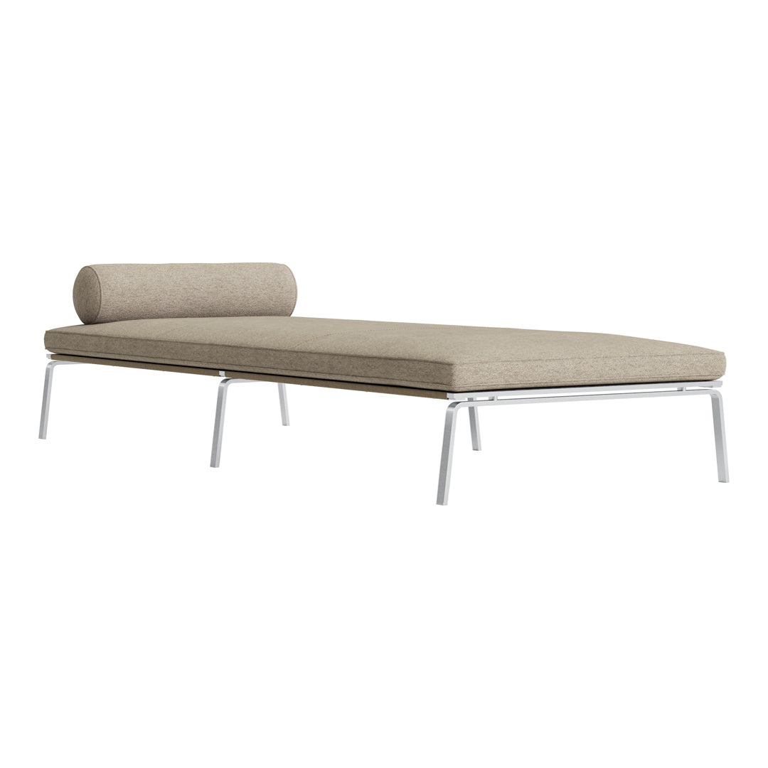 Beige daybed with a cylindrical pillow and sleek chrome legs, featuring a subtle textured fabric pattern.