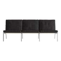Black leather three-seater sofa with sleek silver legs, featuring a minimalist design and smooth, modern lines.
