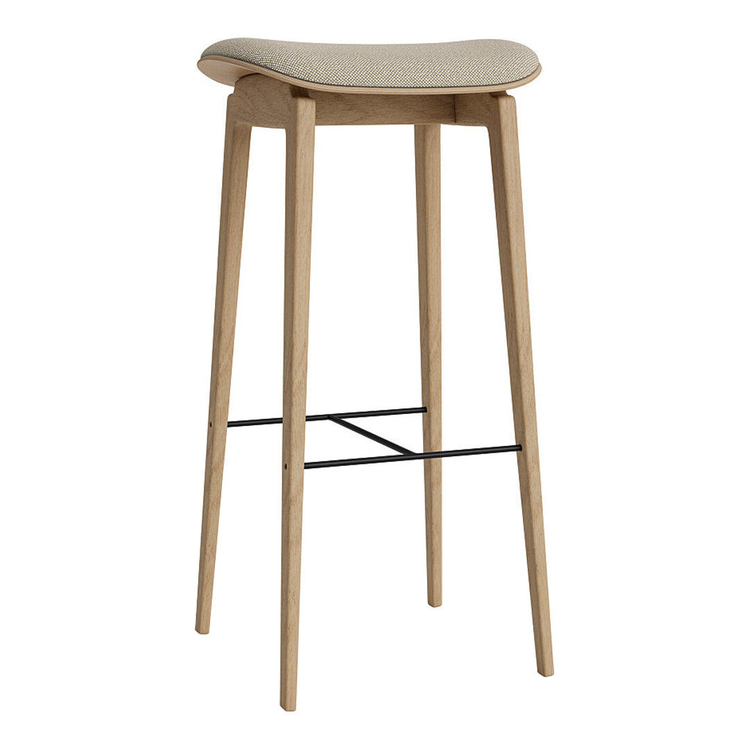Light wood bar stool with a neutral patterned seat and sleek black footrest. Ideal for modern decor.