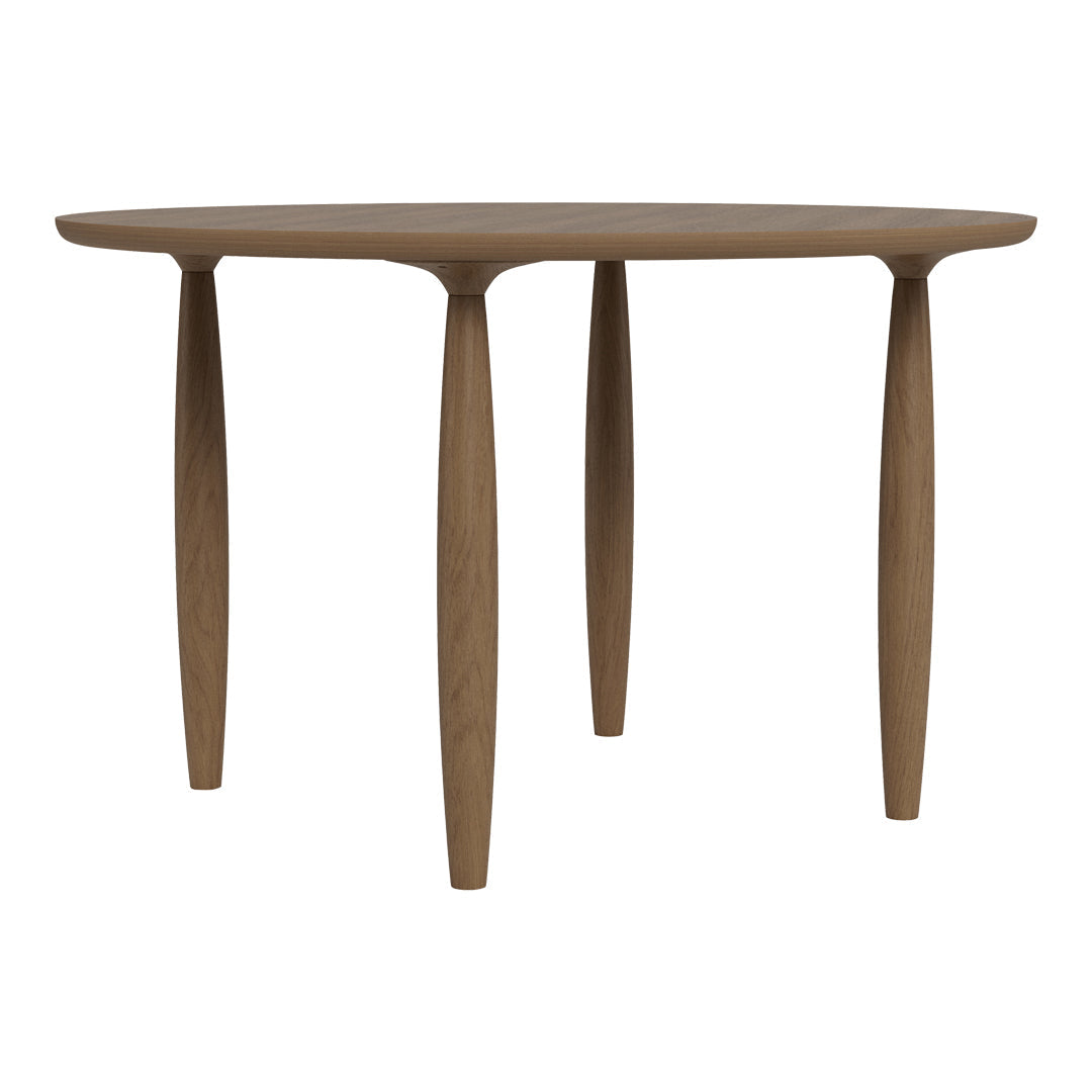 Round wooden table with a smooth, natural finish and four tapered legs in a warm brown hue. Minimalist design.