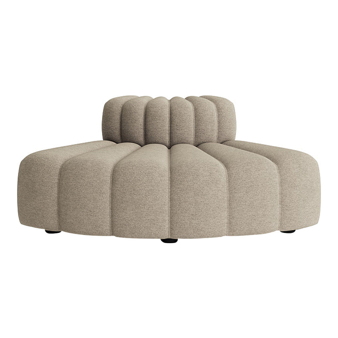 Beige plush sofa with a curved, ribbed design, featuring round and smooth shapes for a modern aesthetic.