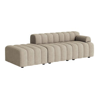 Beige modular sofa with smooth, curved lines and subtle ribbed pattern for a modern aesthetic.