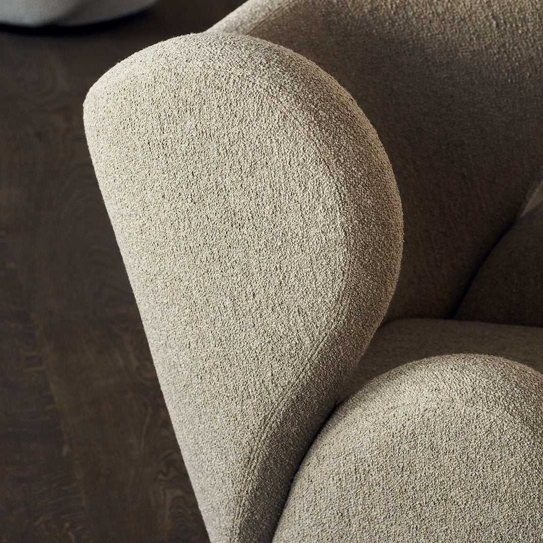 Textured beige upholstery with soft, curved contours, ideal for modern decor. Perfect balance of comfort and style.