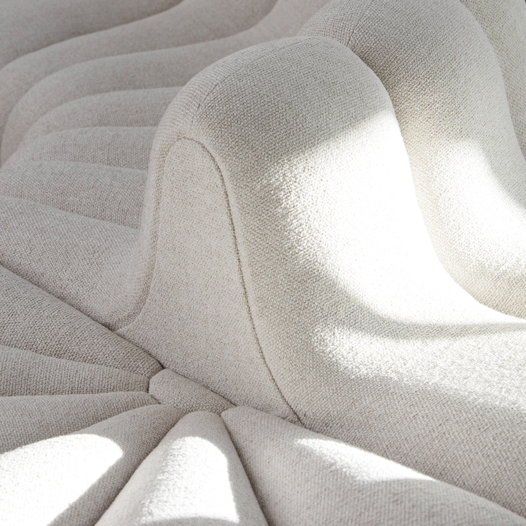 Textured cream upholstery with wavy patterns and soft curves, creating a modern and inviting look.