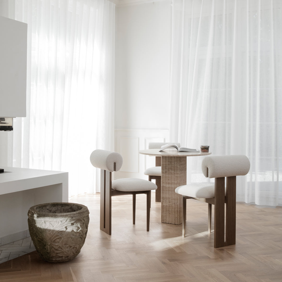 Modern dining set featuring light beige upholstery, natural wood tones, and sleek geometric patterns. Bright, airy ambiance.