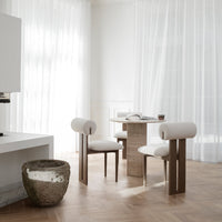 Modern dining set featuring light beige upholstery, natural wood tones, and sleek geometric patterns. Bright, airy ambiance.