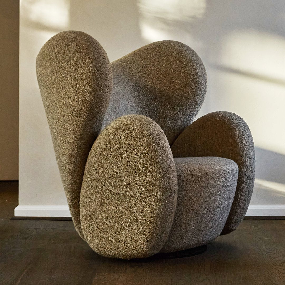 Textured taupe armchair with sculptural, organic shapes and rounded patterns, perfect for modern interior decor.