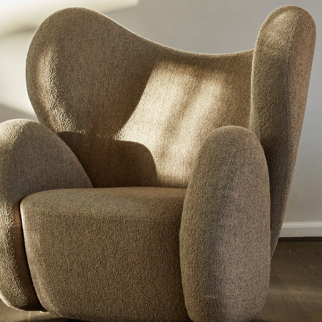 Cozy brown textured chair with soft, rounded edges and a plush fabric finish, perfect for modern interiors.