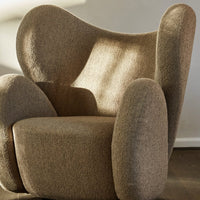 Cozy brown textured chair with soft, rounded edges and a plush fabric finish, perfect for modern interiors.