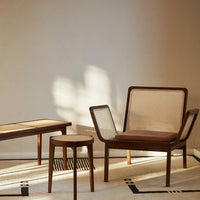Wooden furniture set featuring natural tones, warm brown accents, and textured cane patterns against a neutral backdrop.
