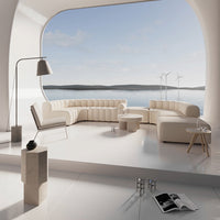 Contemporary cream-colored sofa set with soft curves in a bright, modern living space by the water.