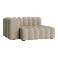 Beige curved sofa with ribbed texture and multiple plush sections, ideal for modern decor.