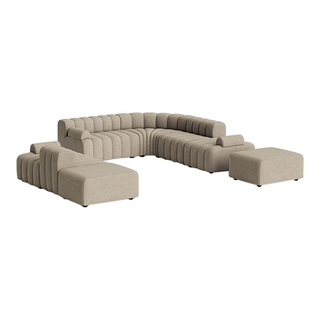 Beige modular sectional sofa with a sleek, modern design and textured, ribbed upholstery. Perfect for contemporary decor.