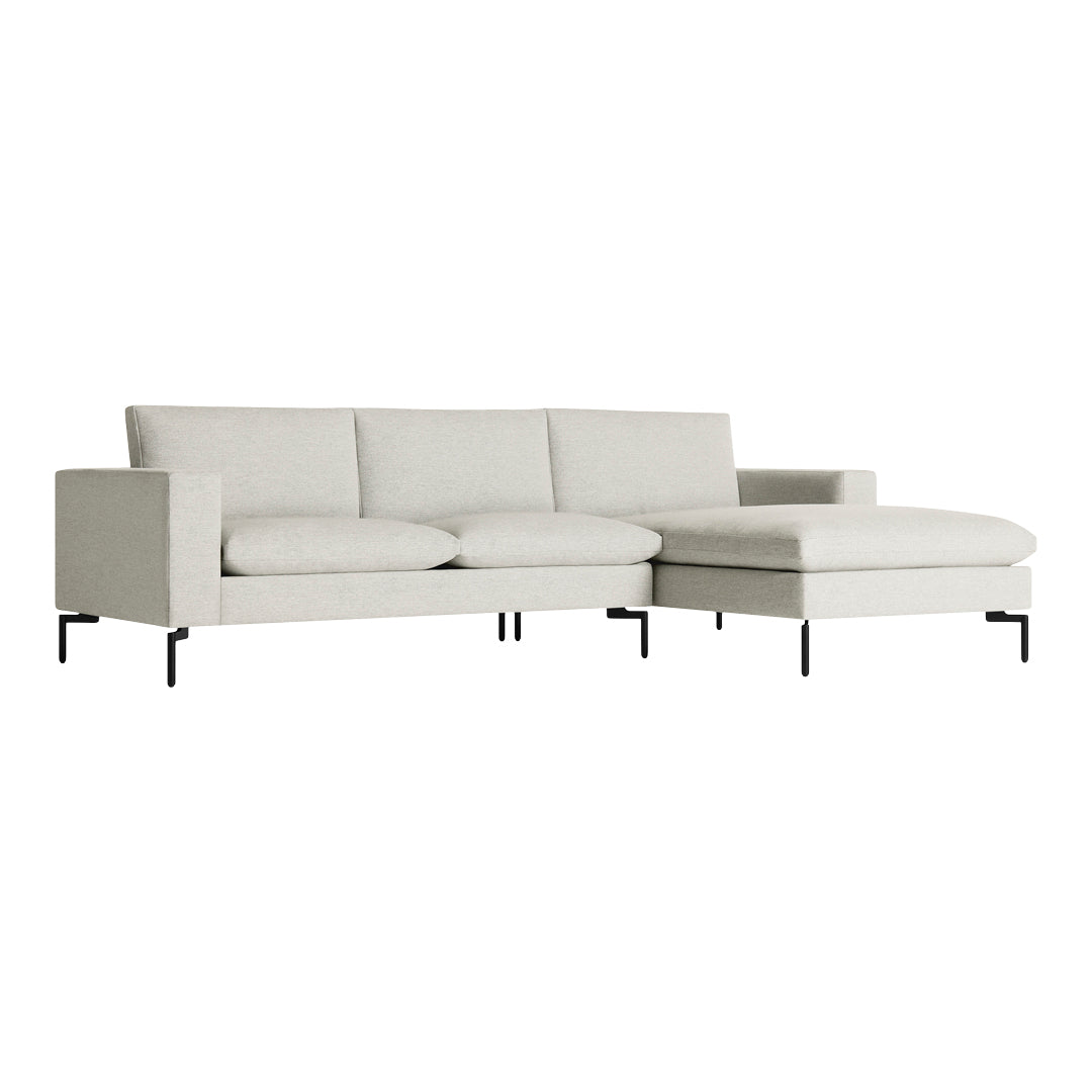 Light grey sectional sofa with a minimalist design and textured upholstery on black metal feet.