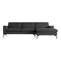 Modern dark gray sectional sofa with clean lines and minimalistic design, featuring soft upholstery and sleek metal legs.