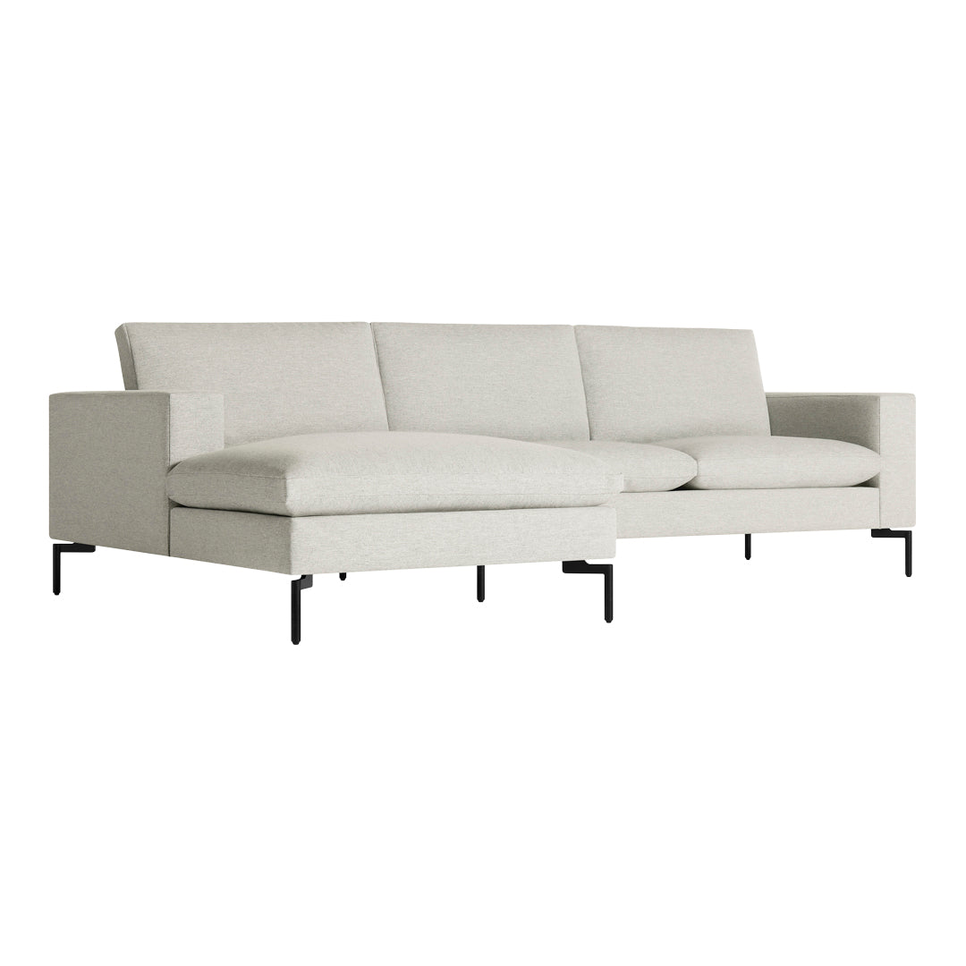 "Modern light gray sectional sofa with clean lines and black metal legs, perfect for contemporary living spaces."