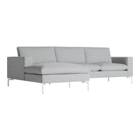 Light gray sectional sofa with a modern design, featuring smooth, minimalist lines and silver metal legs.