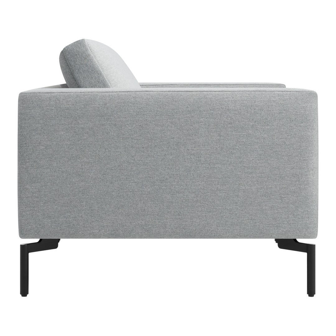 Gray fabric sofa with a textured weave and sleek black metal legs, showcasing a modern and minimalist design.