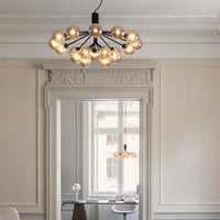 Modern black chandelier with multiple golden glass bulbs, enhancing chic and minimalist decor.