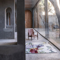 Vibrant floral rug with multicolored patterns on a neutral background, enhancing contemporary space aesthetics.