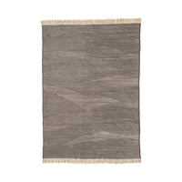 Gray textured rug with subtle wave pattern and fringed edges. Ideal for adding warmth to any space.