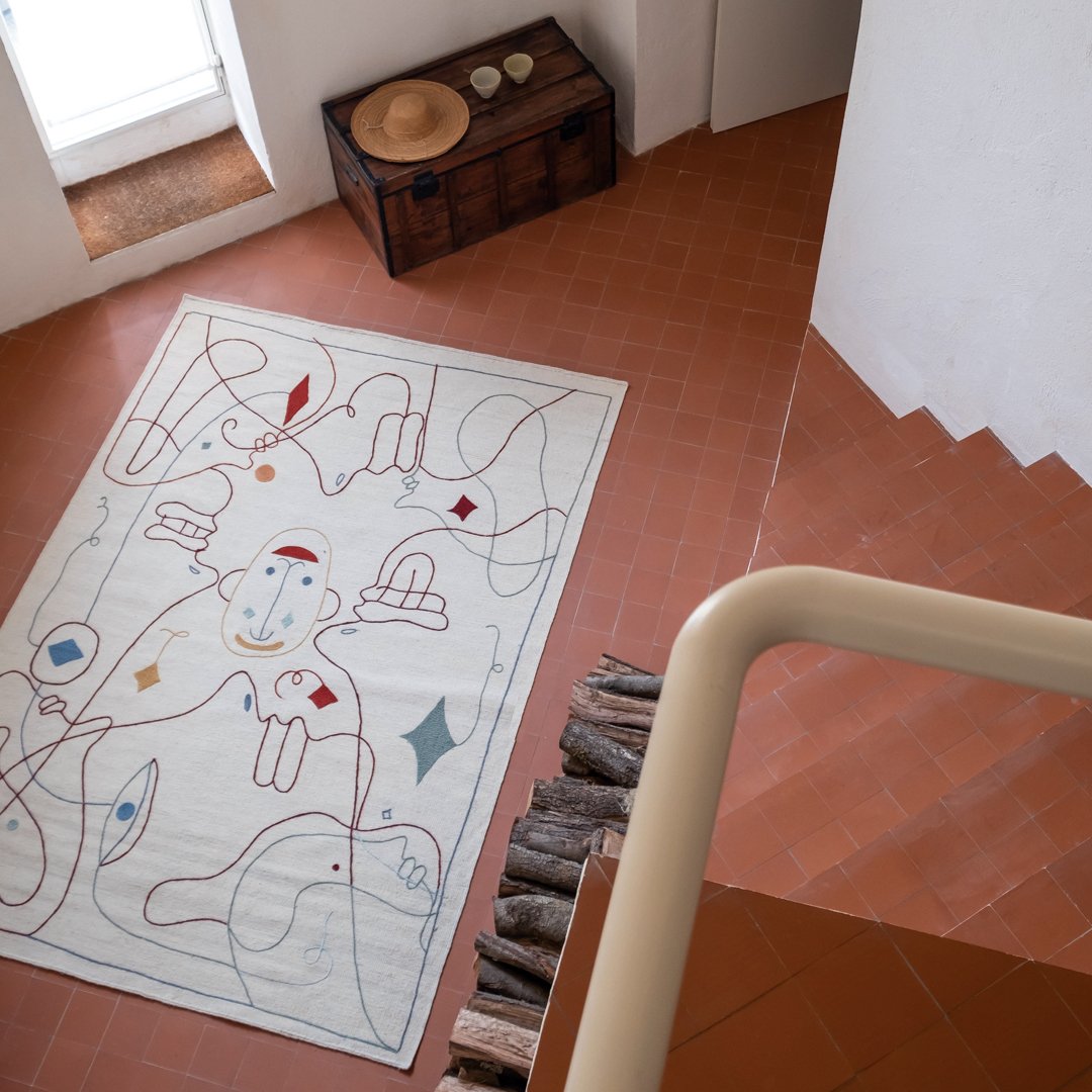 Colorful abstract rug featuring playful patterns in red, blue, and green on a cream background. Perfect for modern decor.