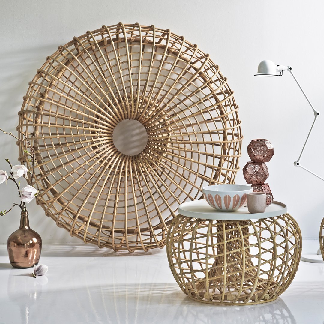 Gold woven pattern decor with cream tabletop, complemented by earthy pottery and a textured round wall art.