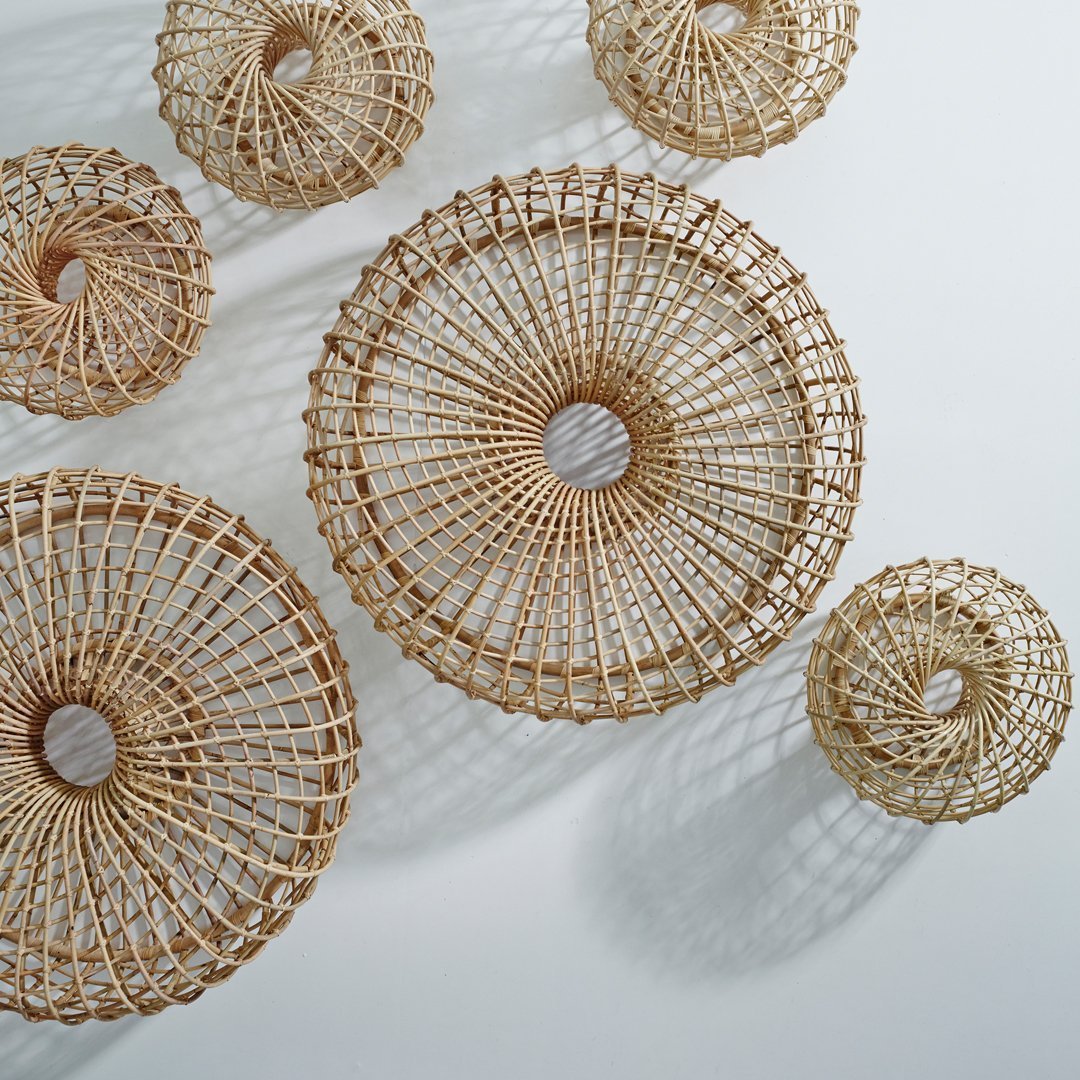 Natural woven rattan baskets in varied sizes and circular patterns, showcasing earthy tones and intricate designs.