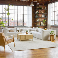 Modern living room featuring soft white tones, beige accents, and natural wood textures in a cozy setting.