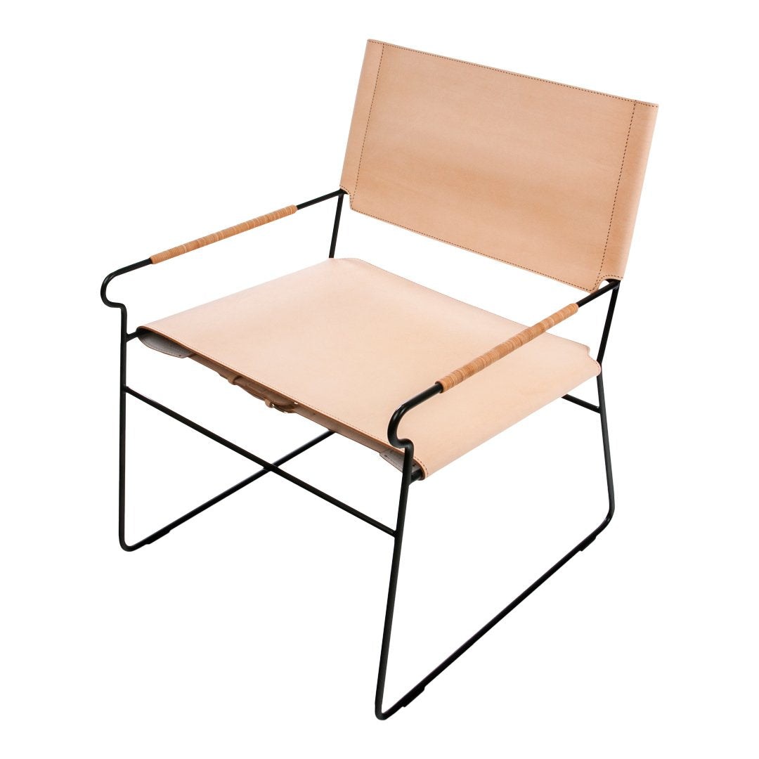 Light beige chair with minimalist design, featuring a smooth wooden seat and backrest supported by a black metal frame.