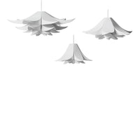 Elegant white pendant lights with layered, floral-inspired designs hanging against a minimalist background.