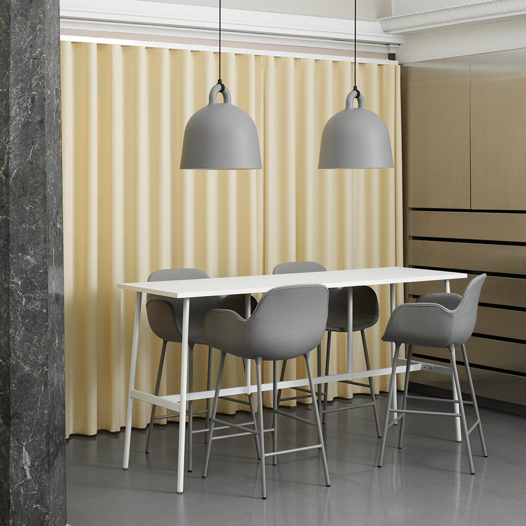 Modern dining set with gray chairs and pendant lights, complemented by soft beige curtains and sleek white table.