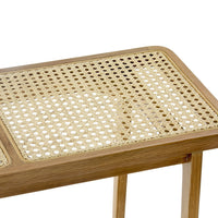Natural bamboo table with a light honey finish and intricate woven cane pattern on the top surface.