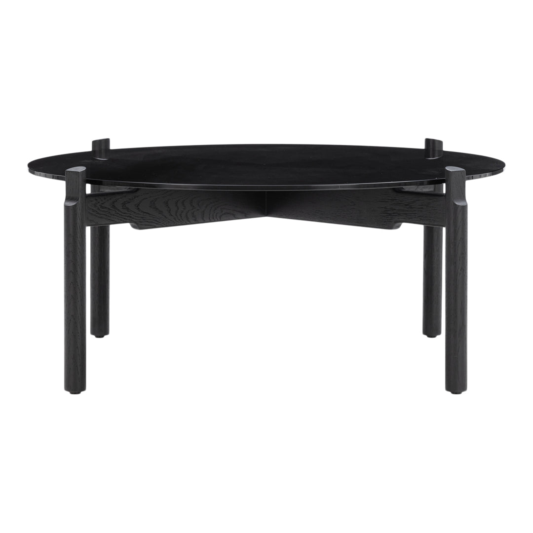 Black oval coffee table with a minimalist design and contrasting wood grain patterns. Elegant and modern style.