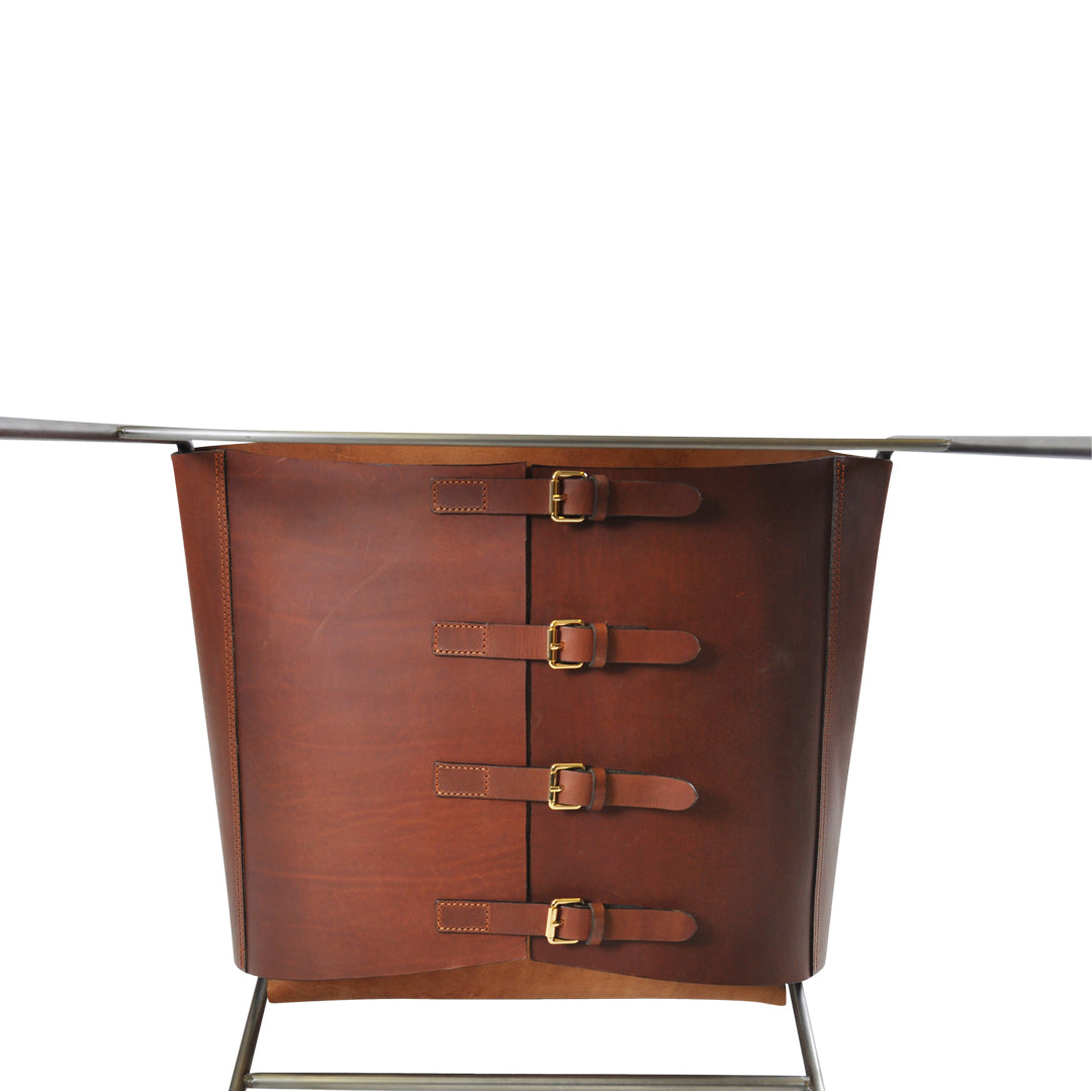 Brown leather bucket with four decorative buckles, featuring a sleek, modern design and metallic accents.