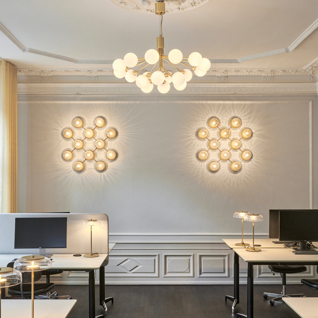 "Chic modern lighting with warm white tones and elegant circular patterns, enhancing office decor."