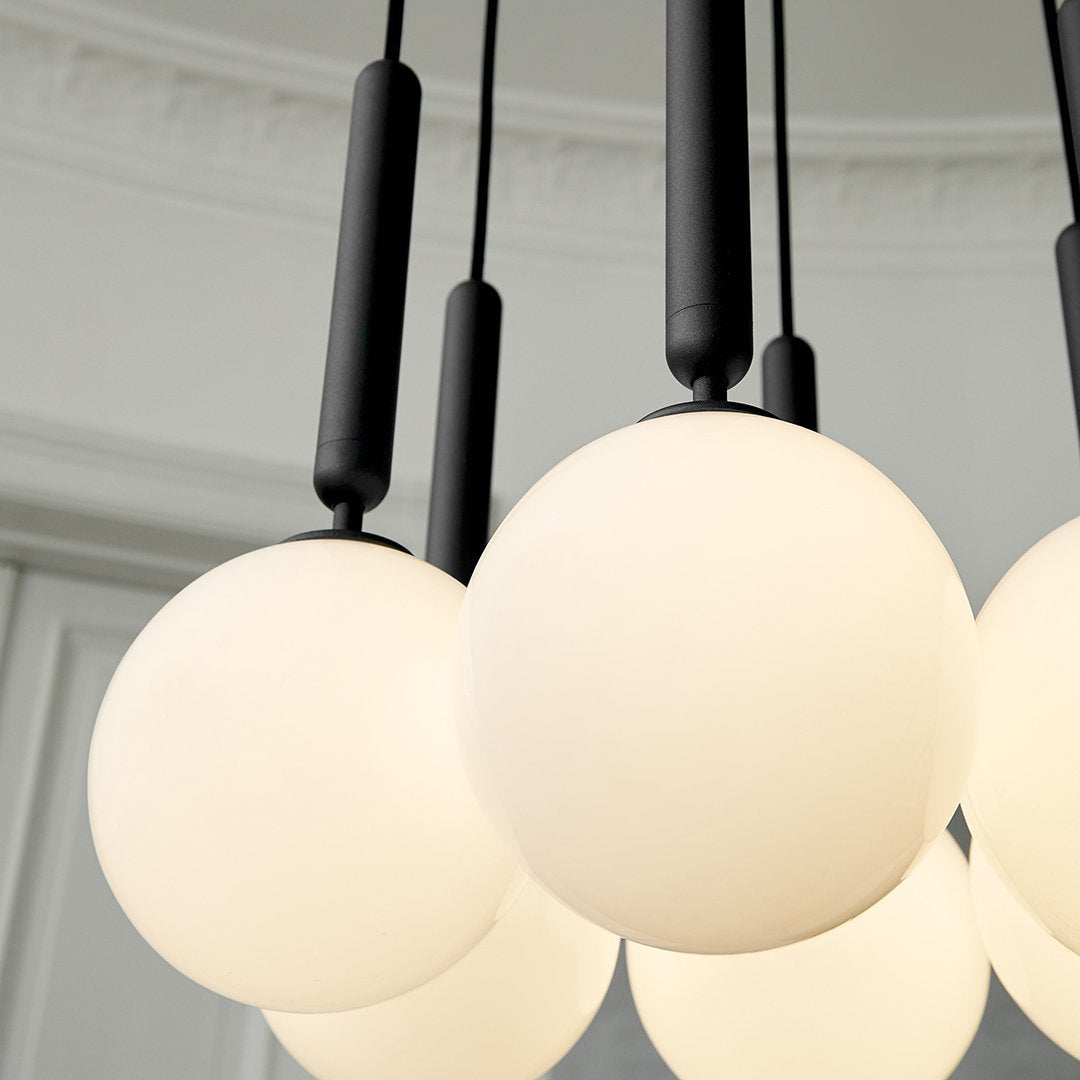 Black pendant light with round frosted glass shades, showcasing a modern, minimalist design and sleek black accents.