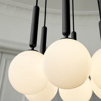 Black pendant light with round frosted glass shades, showcasing a modern, minimalist design and sleek black accents.