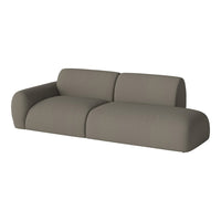 Stylish modular sofa in a soft taupe color with a smooth fabric texture, perfect for modern interiors.
