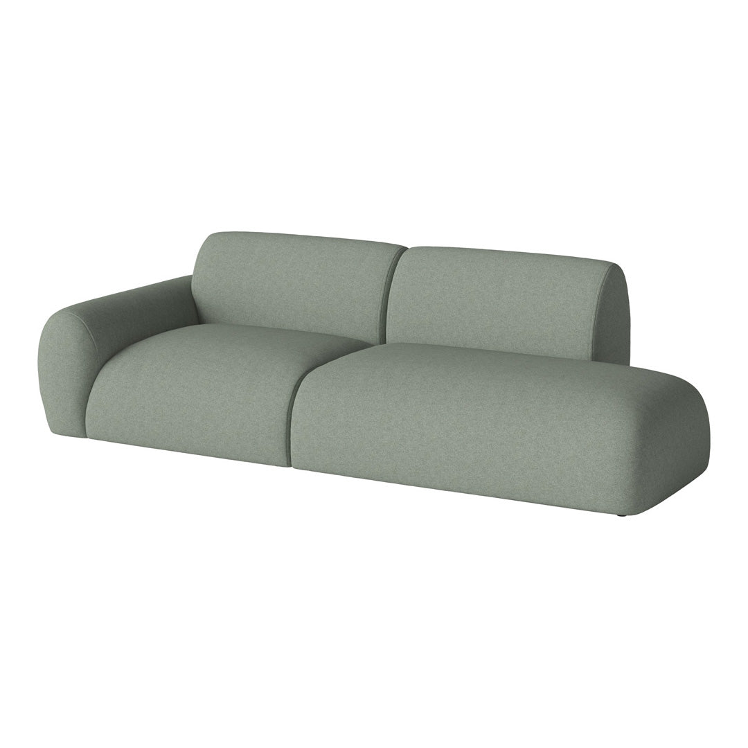 Soft green modular sofa with a modern, minimalist design and textured fabric upholstery. Perfect for stylish living spaces.