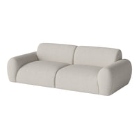Light beige, textural fabric sofa with a minimalist, modern design and soft, rounded shapes.