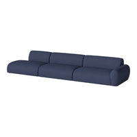 Navy blue sectional sofa with a textured fabric and smooth, rounded edges for a modern aesthetic.