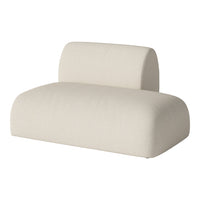 Soft beige fabric lounge chair with smooth curves and textured surface, perfect for modern decor.