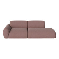 Soft pink sofa with a textured pattern, featuring a modern design and rounded arms for a cozy aesthetic.
