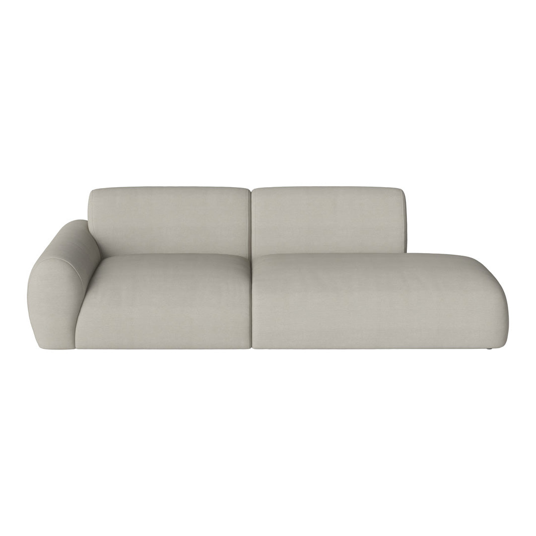 Grey upholstered sectional sofa with smooth, minimalist design and soft fabric texture. Perfect for modern interiors.