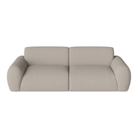 Beige textured sofa with rounded arms, featuring a minimalist design and soft, neutral tones for versatile decor.