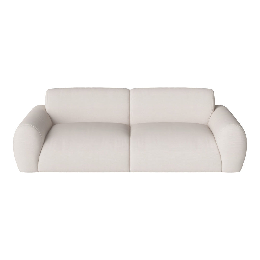 Soft beige sofa with smooth texture and rounded arms, perfect for modern living spaces.