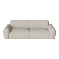 Beige upholstered sofa with a smooth texture and rounded edges, perfect for modern living spaces.